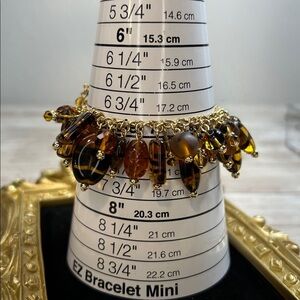 Joan Rivers charm bracelet a mix of amber glass, and tiger-eye striped art glass